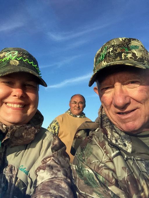 Caribou hunt boat selfie. Liz Richter with Dad George Weber. Guide Thomas Alikashawa in background.
