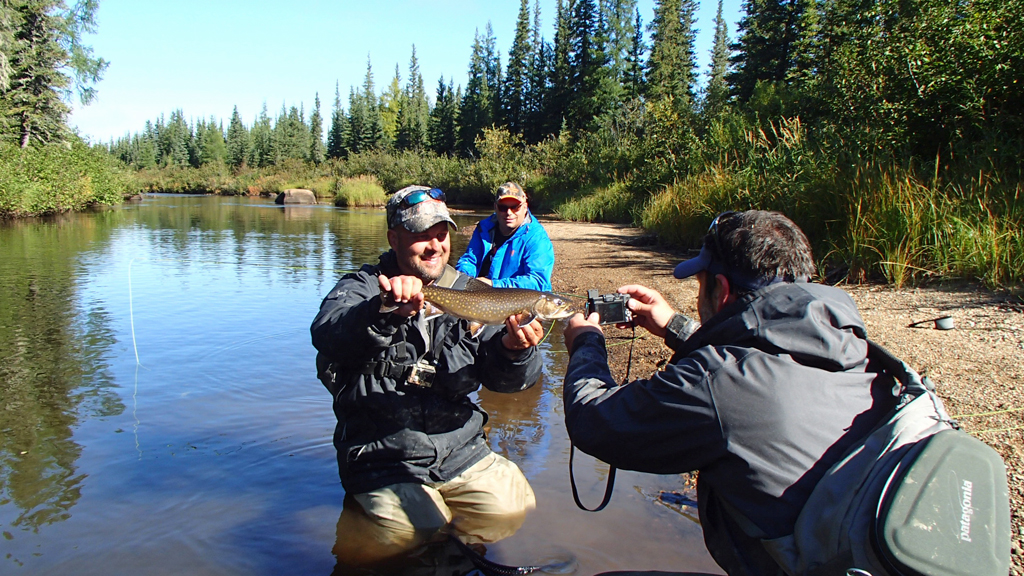 Guide and brook trout both smiling. Catch and release