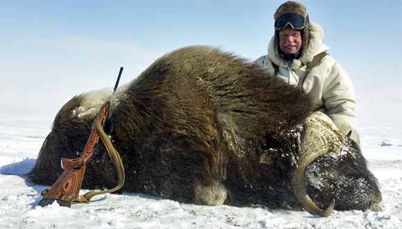 Weston Millward smiling with his musk ox.